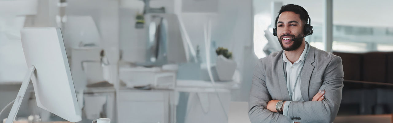 happy telemarketer with headphones at computer 
