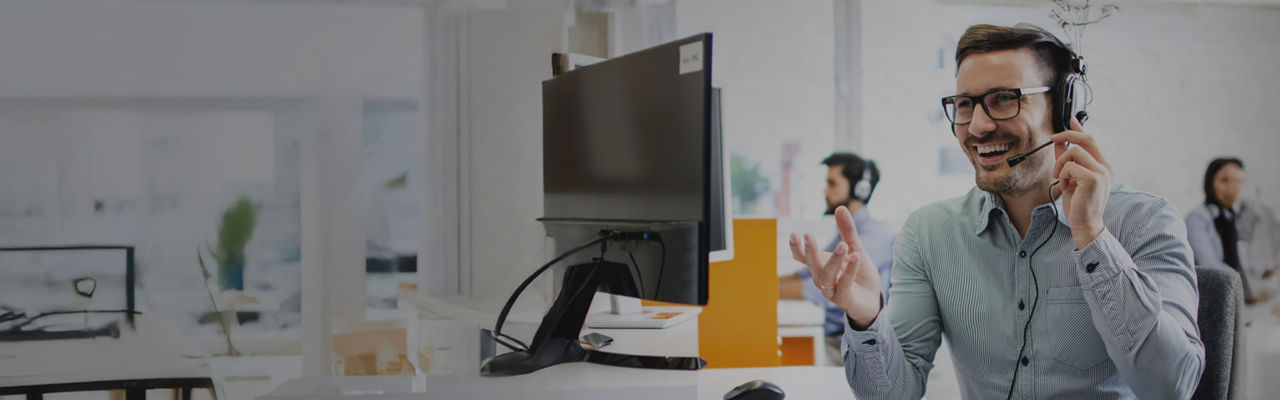 telemarketer with headphones at computer