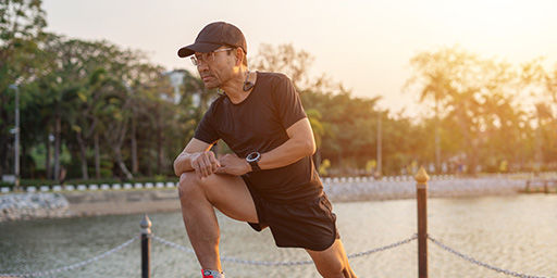 man stretching outside after a run 