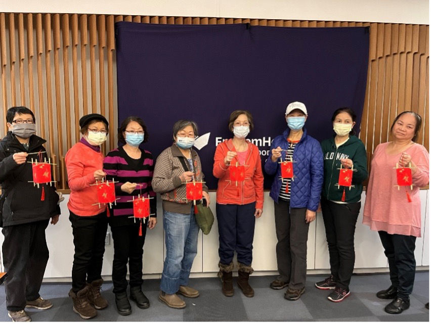 Community members show off the lanterns they created after participating in an art and relaxation class in celebration of Chinese New Year. 