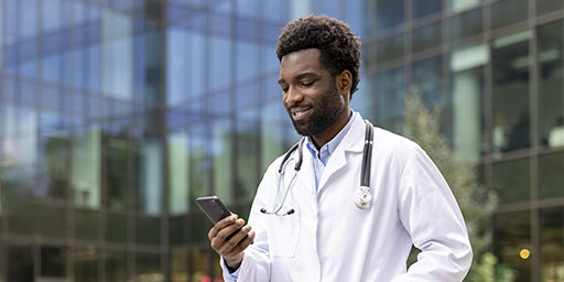 health care providers lookung at phone outside