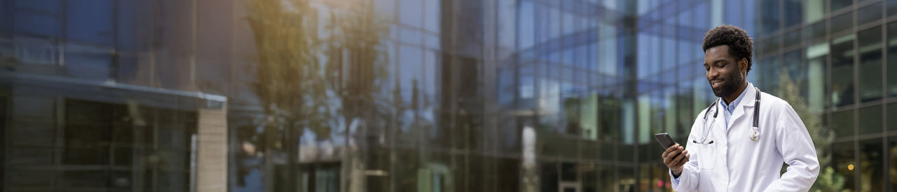 health care providers lookung at phone outside