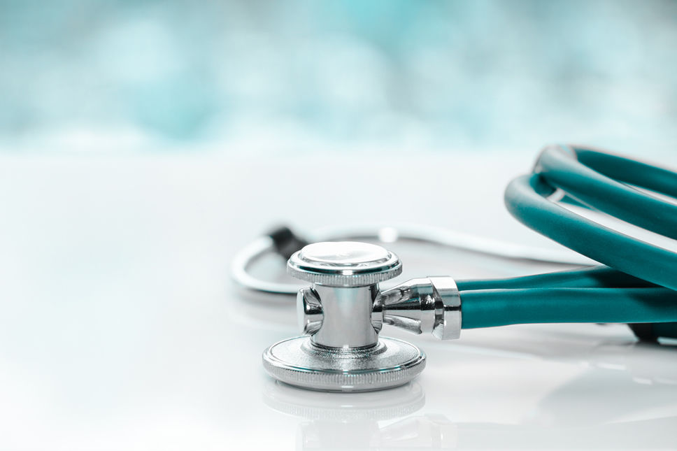 Stethoscope or phonendoscope on a doctor's white desk on cloudy morning, for treatment of cold or flu.