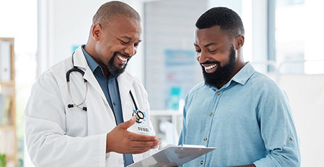 patient and doctor smiling and looking at notes