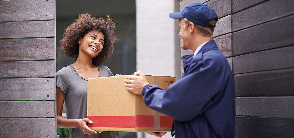 man handing woman a box 