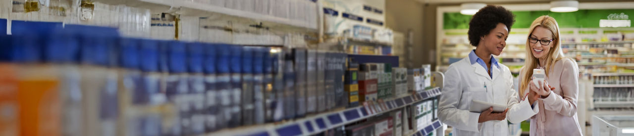 pharmacist talking to customer in pharmacy