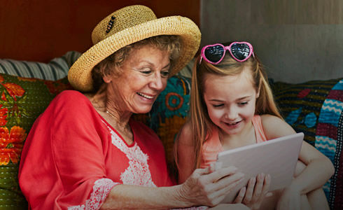 Grandma and Granddaughter using tablet device