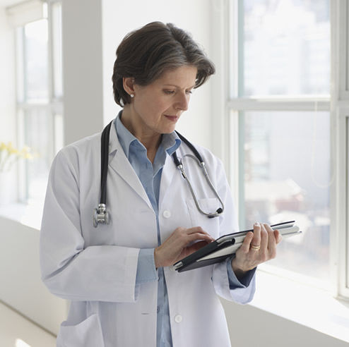 Doctor using tablet device at hospital