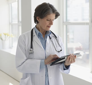 Doctor using tablet device at hospital