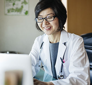 Health care provider on laptop.