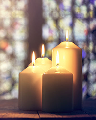 Candles burning in a church background