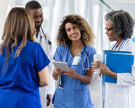 A group of multi-generational health care providers smiling