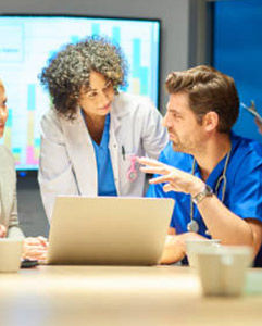 providers discussing a presentation with computer