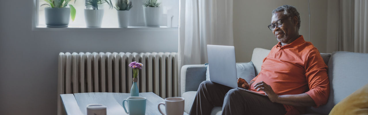 senior man on laptop at home