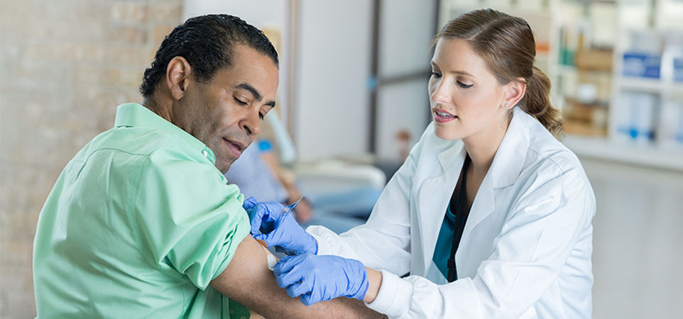 man getting injection at pharmacy