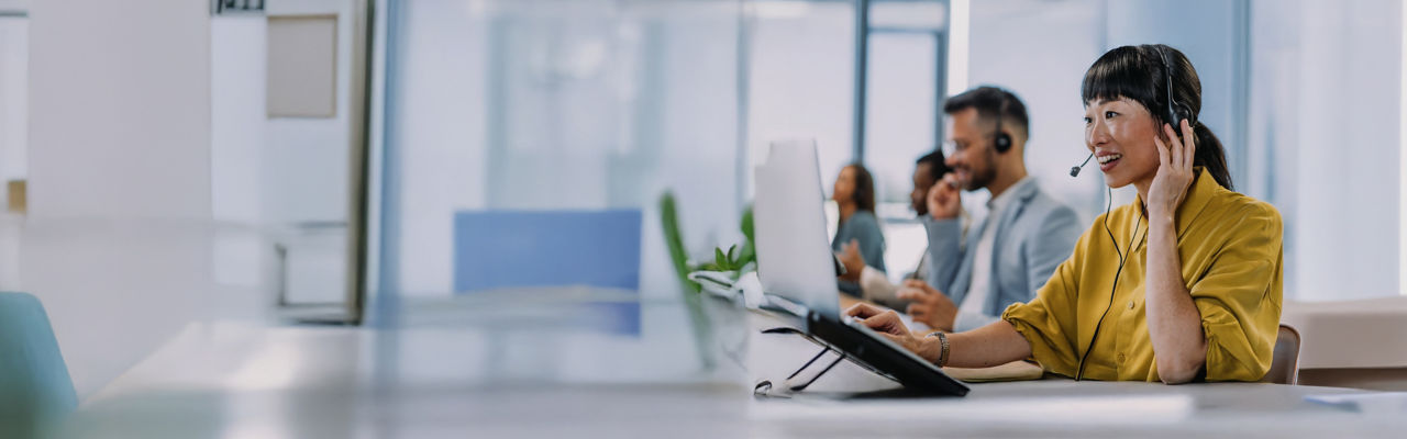 telemarketer looking at laptop at desk