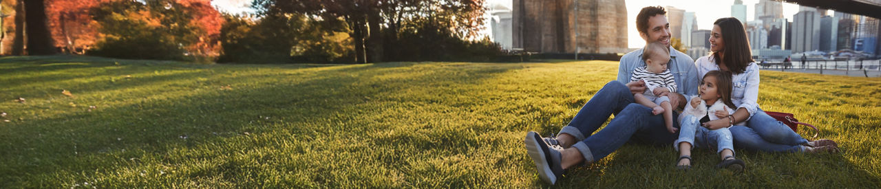 young family sitting in the park