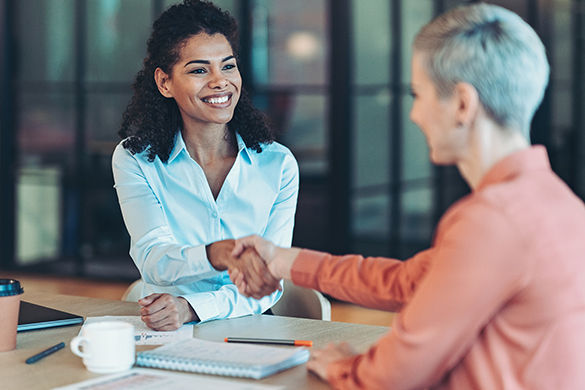 Businesswomen shaking hands in the office