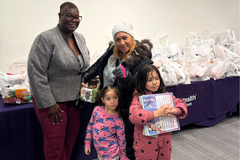 New York State Senator Roxanne Persaud at a toy giveaway event with staff from EmblemHealth Neighborhood Care East New York, providers from AdvantageCare Physicians East New York Medical Office, and community members. 