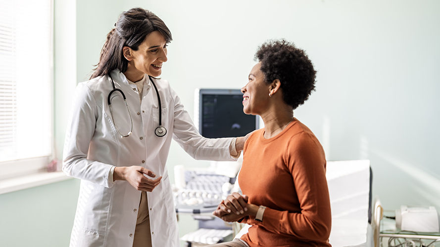 Happy female health care provider with female patient