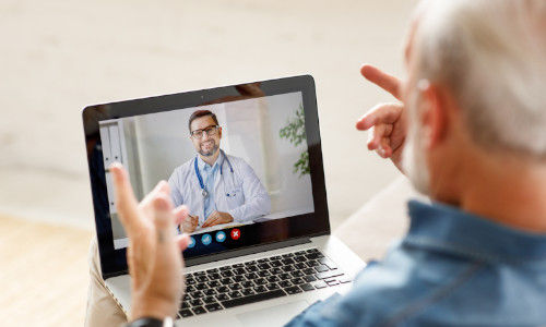 Older man on virtual call on tablet