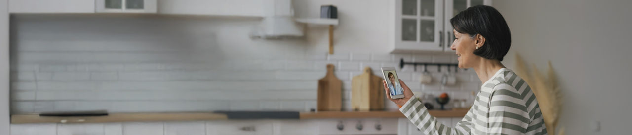 virtual doctor visit at home in kitchen