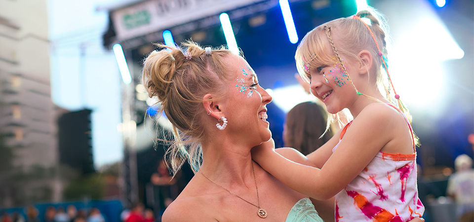 mother with daughter at music festival