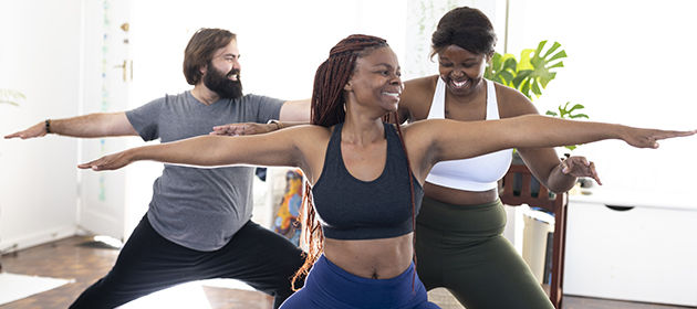 Happy young adults in a yoga class