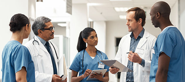 A diverse health care team standing together in a hospital setting